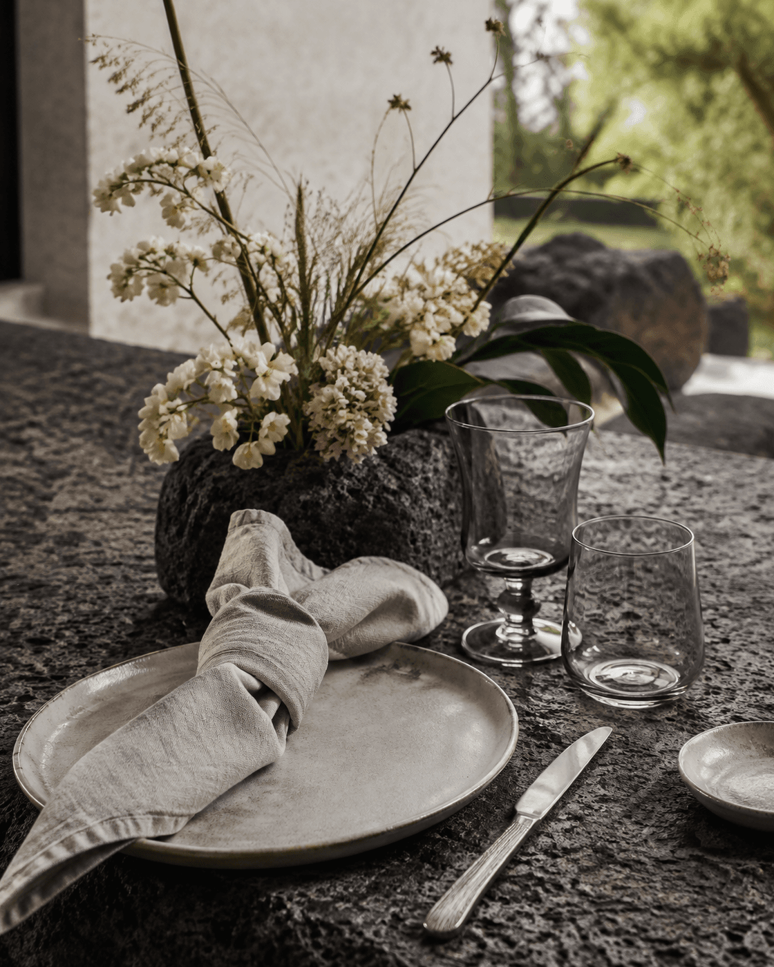 Concept of locally inspired limestone, linen and floral materials